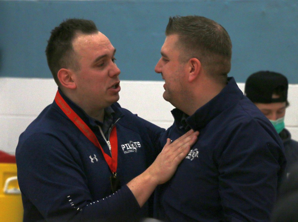 Providence men's volleyball coach Cody Quiring (left) shares an embrace with the program's women's volleyball head coach, Kyle Guenther after the men's championship. Both coaches announced they would be leaving Providence after this season. (Cassidy Dankochik The Carillon)