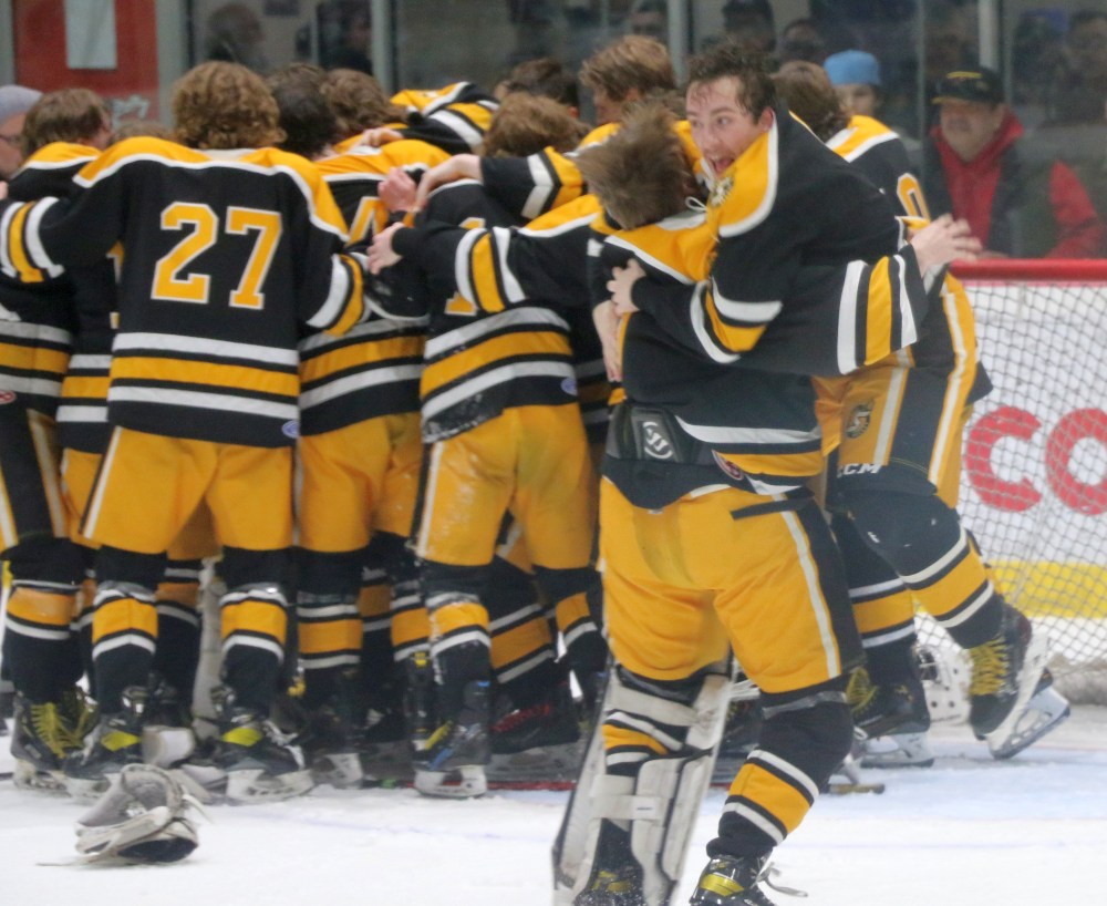 Seth Bergman leaps into the arms of fellow grade 12 player William MacDonald in celebration after the final whistle. (Cassidy Dankochik The Carillon)