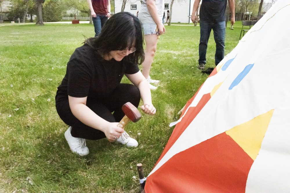 SVJETLANA MLINAREVIC THE CARILLON
Steinbach Regional Secondary School student Arina Yarushok hammers in a wooden spike during the erection of a teepee on the grounds of the Mennonite Heritage Village on May 17, 2023.
