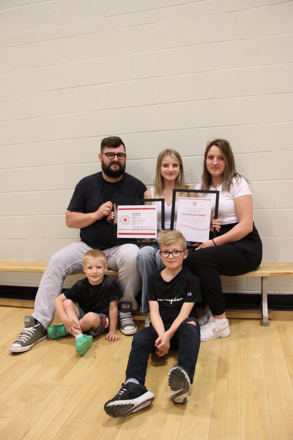 JURA MCILRAITH THE CARILLON
Emily Neufeld (centre) holds her Red Cross Rescuer Award and replacement babysitting certificate alongside her parents Andreas and Natalie and brothers Levi and Jamie. Neufeld was issued the awards at a school assembly Tuesday morning.