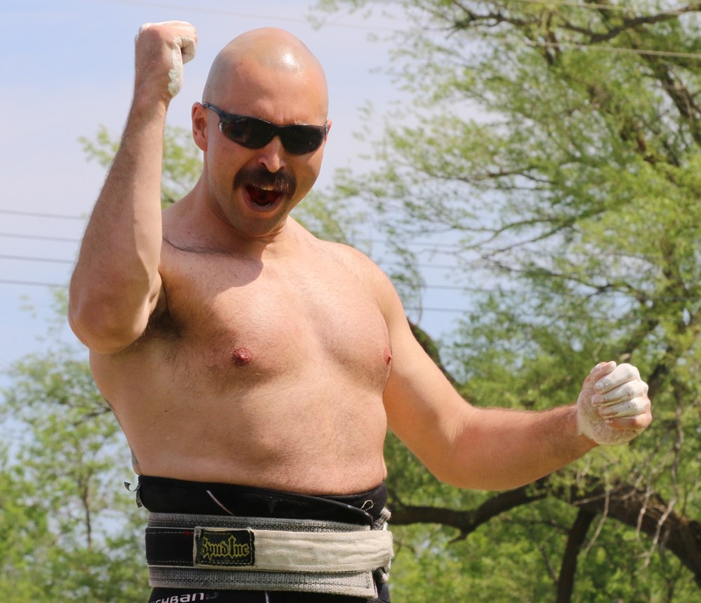 Ryan Deloli celebrates after hearing he won the Hercules Hold event by only one second. (Cassidy Dankochik The Carillon)