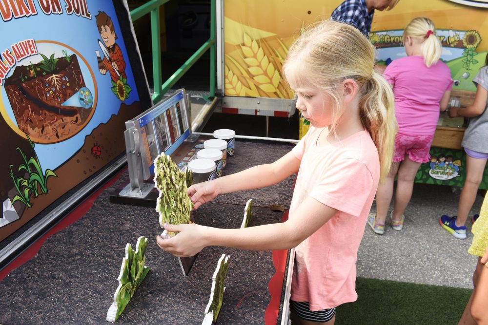 SVJETLANA MLINAREVIC THE CARILLON
Second grader Janelle Enns learns about soil on June 9, 2023. The activity was part of Agriculture in the Classroom’s Seed Survivor program, which teaches students about plants and how to grow them.