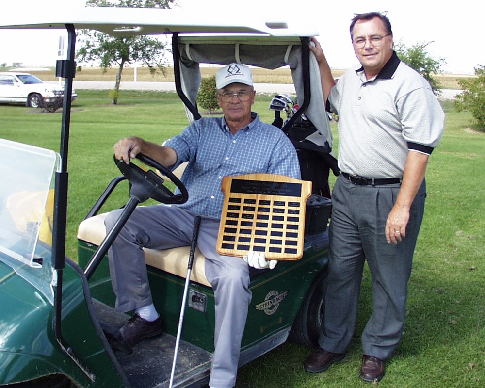 Ben Penner and Jack Kehler display the sponsorship plaque they received for posting the low gross and low net scores in the first season of the mixed senior league at the Steinbach Fly-In Golf Course.