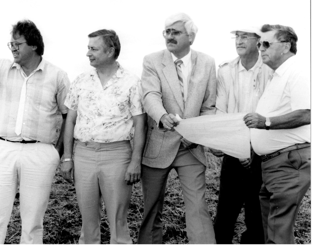 Clare Braun, Niverville Mayor Gil Wiebe, Jerry Cousin, engineer; land owner George Dueck, and golf course designer John Thompson look over the possible location of the first tee of a future golf course in Niverville.