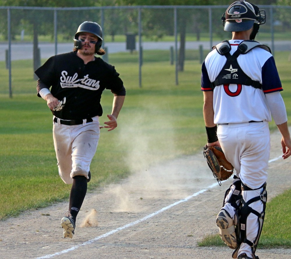 A senior Sultans player kicks up dust as he sprints home to score a run against Elmwood June 12. (Cassidy Dankochik The Carillon)