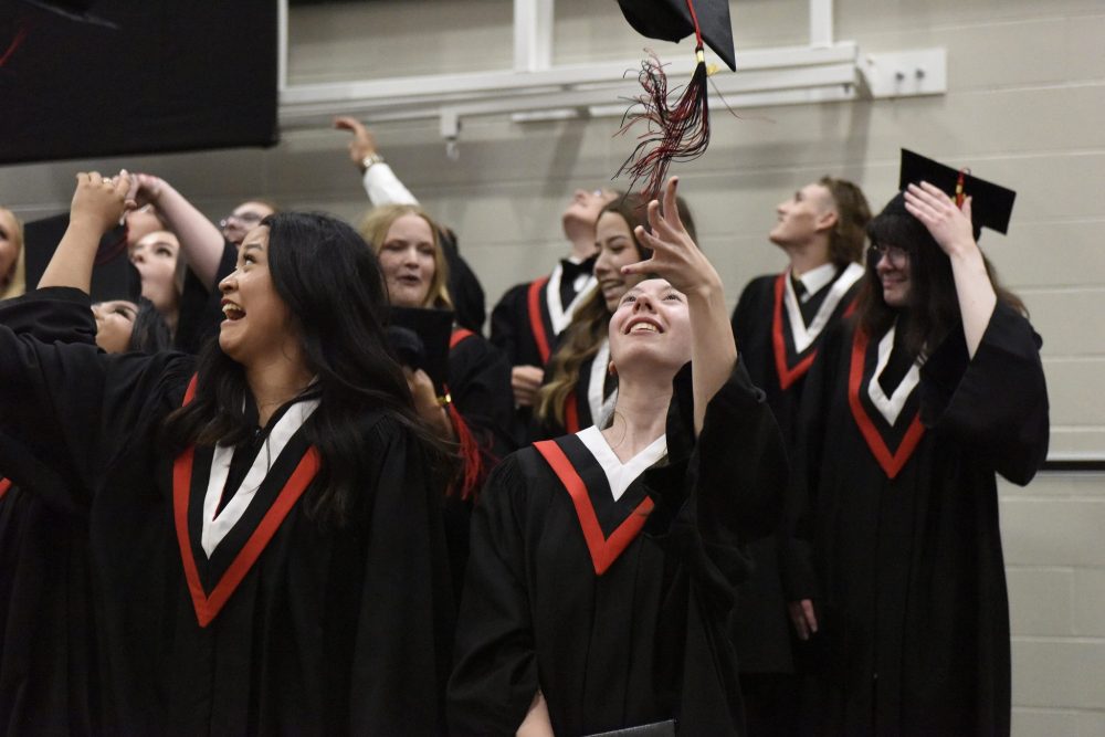 SVJETLANA MLINAREVIC The Carillon
Niverville High School graduate Sarah Gugenheimer tosses her mortarboard into the air at the end of her graduation ceremony on June 28, 2023.