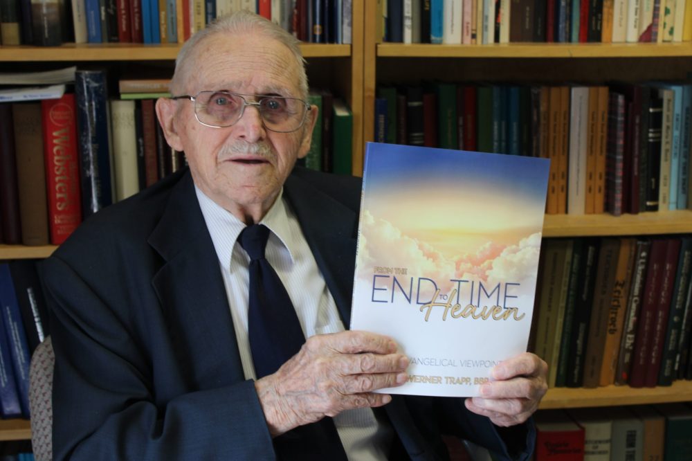 GREG VANDERMEULEN THE CARILLON
Rev. Werner Trapp poses with the book he authored, in some ways a lifetime in the making. The 96-year-old will be selling From the End Time to Heaven at Clearspring Centre, Aug. 3 to 5.