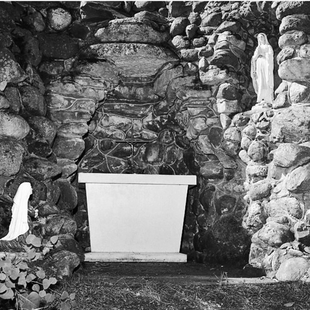 CARILLON ARCHIVES
The St Malo grotto, built in 1896, has undergone many changes by parish priests over the years, and the grounds and chapel above it are visited by thousands every year in August. A trickle of water runs beneath the statue of St. Bernadette to the left of the altar, representing the holy water of Lourdes.