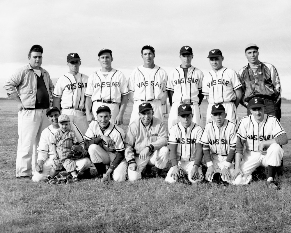 This 1954 Vassar baseball team Includes Manitoba Baseball Hall of Famers David Boileau, Aime Cote, Jim Cote and Denis Cote along with the usual number of players with Vassar family names. Posing for The Carillon News photographer after another tournament win are: Front row; Elmer Boutang (with son Randy on his lap), Cub Cayer, George Boutang, manager; Denis Cote, Gary Boutang and Andy Alexiuk.
Standing are; Norman Boutang, coach; Aime Cote, David Boileau, Richard Cayer, Marvin Hovorka, Jim Cote and, David Cayer, coach
