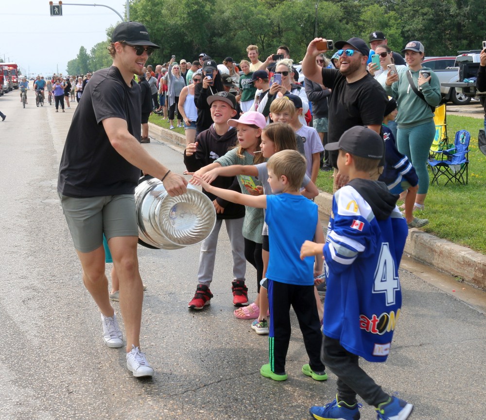Brett Howden shows off the Stanley Cup to attendees at the Oakbank cup parade. For the first time, members of the Stanley Cup winning team had their names engraved on the trophy before the annual cup tour begins. (Cassidy Dankochik The Carillon)