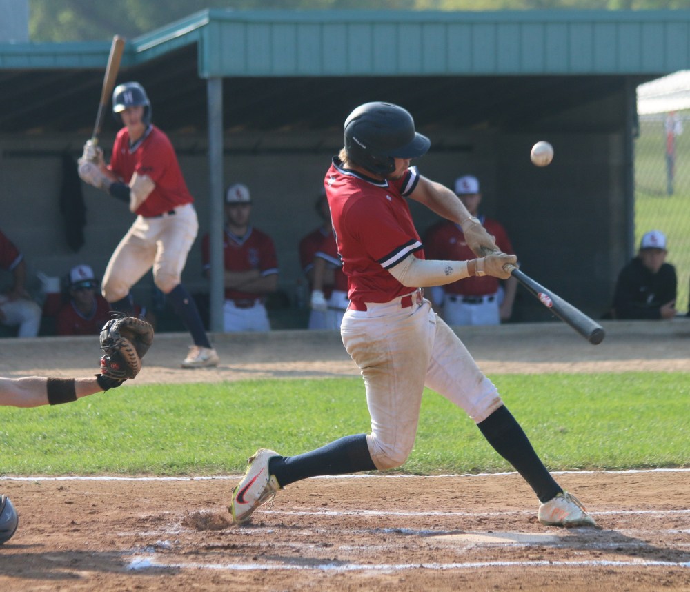 Rylan Penner makes contact while Cody Gunderson looks on from the on-deck circle. The Carillon Sultans' duo batted consecutively in the lineup during the semi-finals. (Cassidy Dankochik The Carillon)