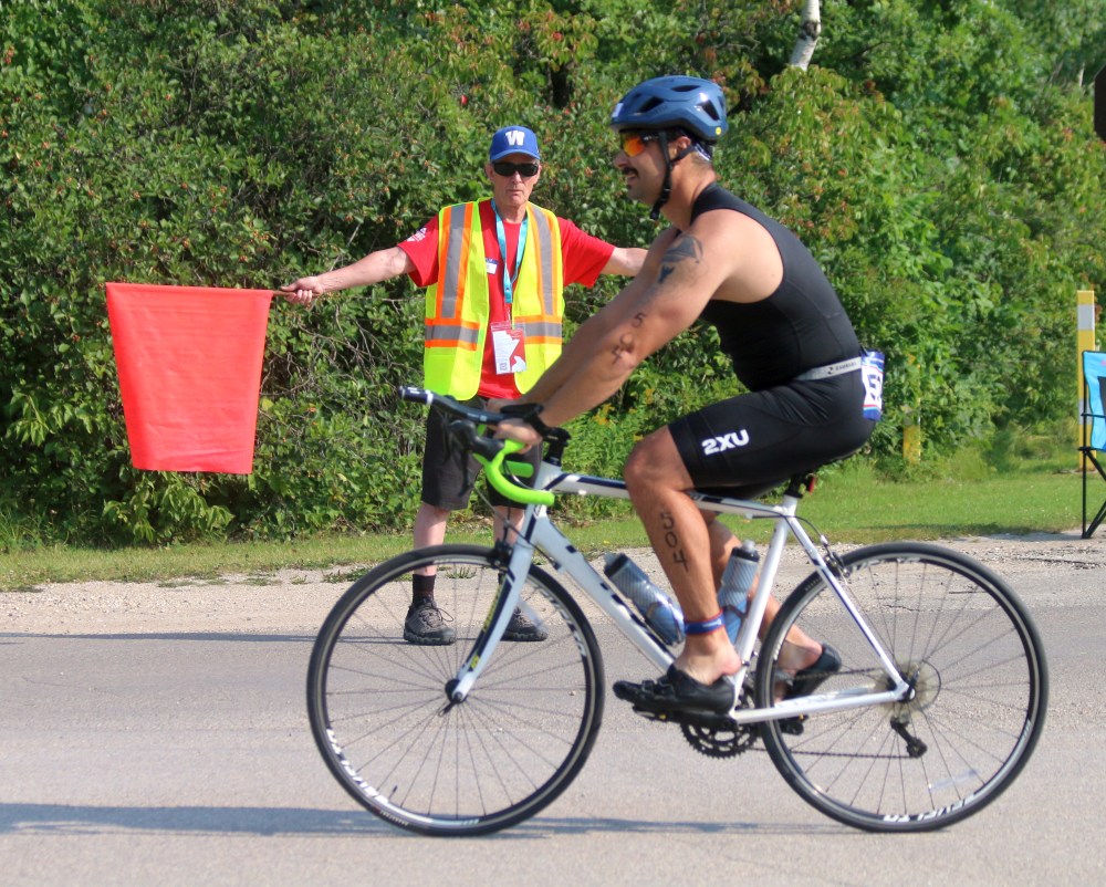 A volunteer directs a cyclist on where they should go. (Cassidy Dankochik The Carillon)