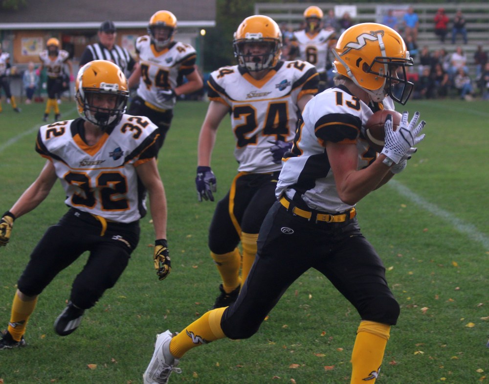 Grade 10 Juddah Wholgemuth took the first defensive snap of the game back for a touchdown after this interception. (Cassidy Dankochik The Carillon)