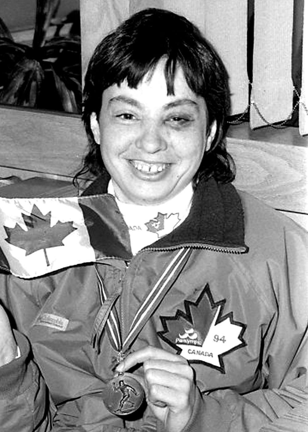 Terry Lynn Johnson proudly displays the bronze medal she won for cross-country skiing at the 1994 Paralympic Winter Games in Norway.