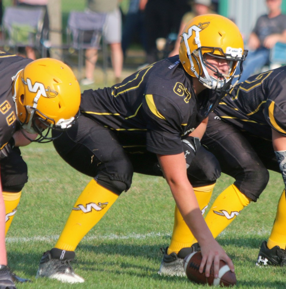 Koren Letkeman keeps his eye on the Springfield defensive line as he prepares to snap the ball during pre-season action. (Cassidy Dankochik The Carillon)