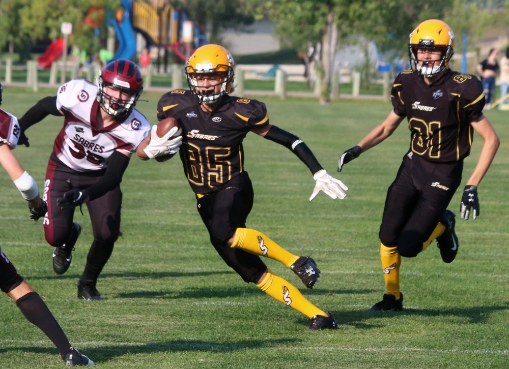 Receiver Tyson Hruda jukes out a defender en route to a big gain. (Cassidy Dankochik The Carillon)