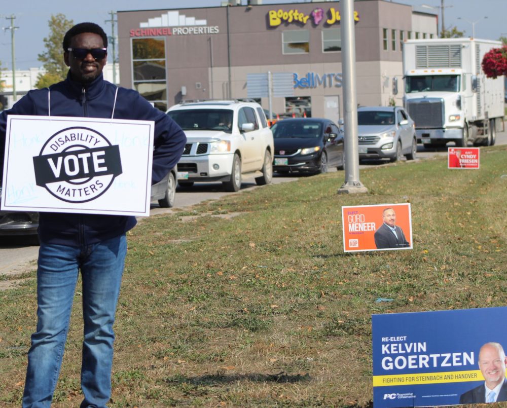 CHRIS GAREAU THE CARILLON
Supporters for disability rights get honks of support from passing motorists at Brandt and Main Streets as part of a province-wide rally by Disabilities Matters Vote Sept. 19 to get voters thinking about their issues ahead of the Oct. 3 election.