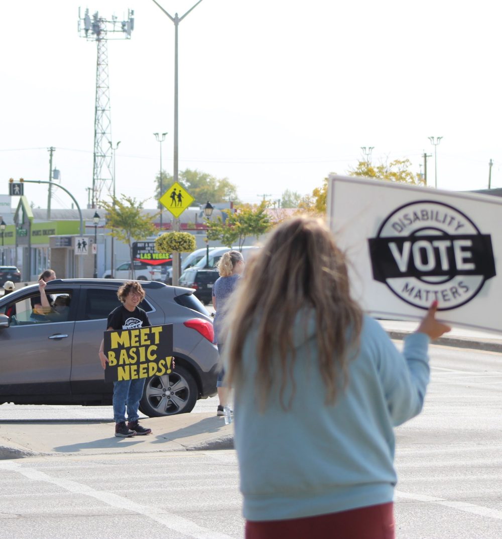 CHRIS GAREAU THE CARILLON
Supporters for disability rights get honks of support from passing motorists at Brandt and Main Streets as part of a province-wide rally by Disabilities Matters Vote Sept. 19 to get voters thinking about their issues ahead of the Oct. 3 election.