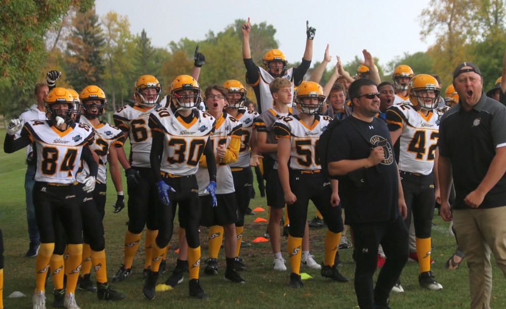 The Steinbach sideline celebrates the opening touchdown of the game, an interception return for a score. It was Steinbach's first varsity football win since 2021. (Cassidy Dankochik The Carillon)