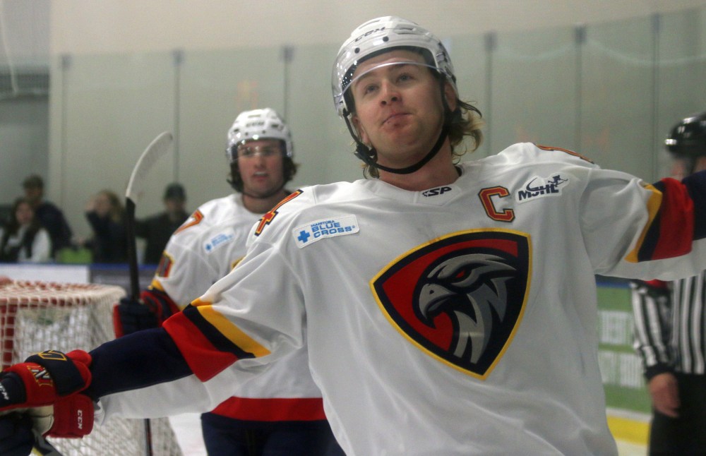 Brett Tatayrn fights off a smile while celebrating scoring a goal against Portage. (Cassidy Dankochik The Carillon)