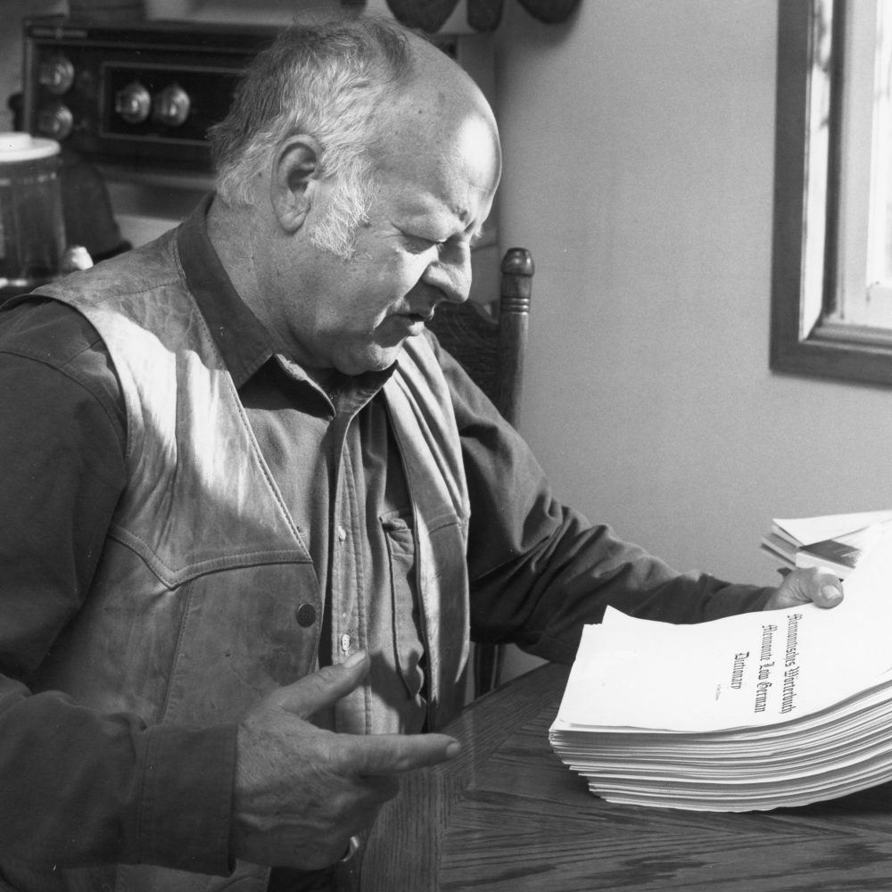 CARILLON ARCHIVES
In this 1995 photo, Jack Thiessen examines a copy of the manuscript for the Mennonite Low German dictionary being prepared for publication.
