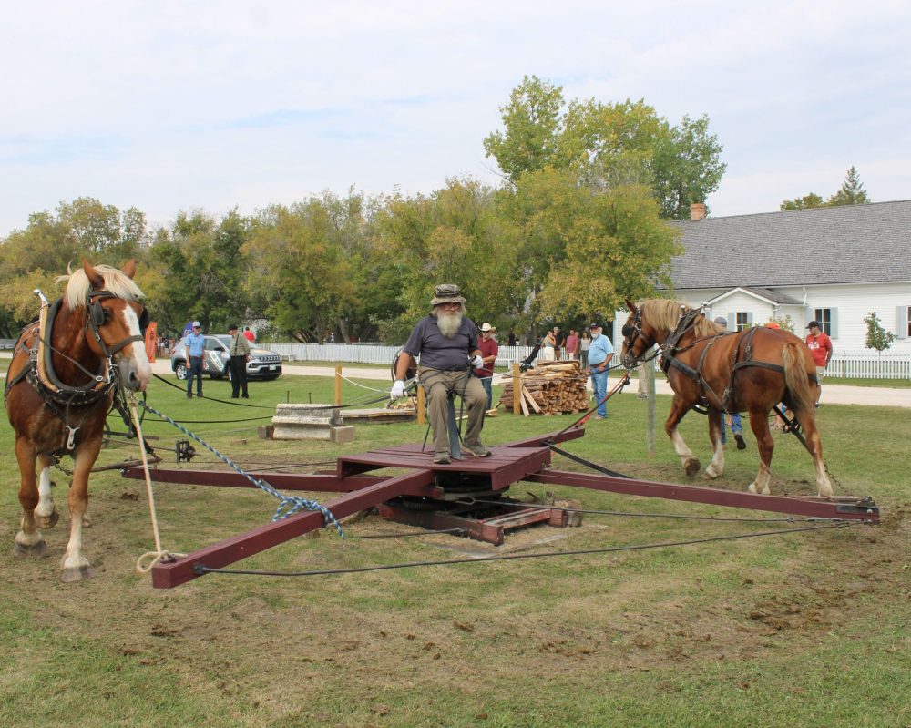 (double-click to edit)
GREG VANDERMEULEN THE CARILLON
Melvin Rush, seated on the platform, operates the controls of this two horsepower “sawmill” at the MHV.