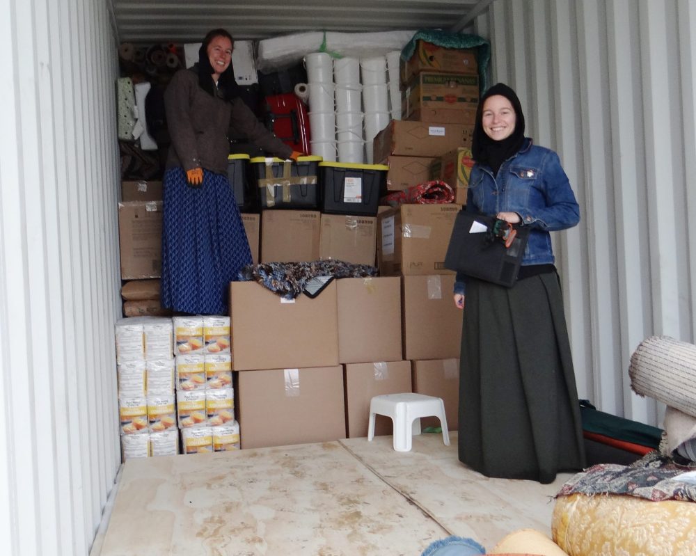 WES KEATING THE CARILLON
Greta Kleinsasser, with clipboard, and her sister Brooke check goods being loaded into a container for delivery to Africa this week.