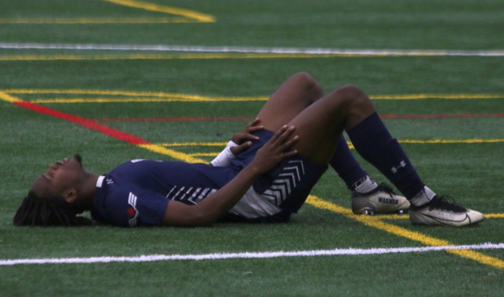 Joel Umeh could do nothing but collapse after the final whistle of the Manitoba Colleges Athletic Conference men's final. Umeh's Providence Pilots just couldn't find a goal, losing 1-0 after conceding a penalty kick in the second half. (Cassidy Dankochik The Carillon)