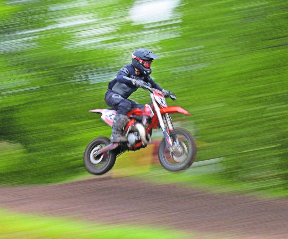 CASSIDY DANKOCHIK CARILLON ARCHIVES
A motocross rider goes over a small jump before the final turn of the Grunthal course.