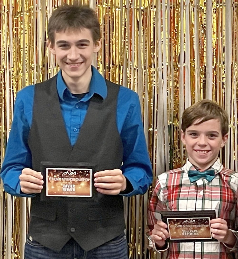 Flippers gymnastics athletes Xavier Reimer (left) and Sullivan Matthews (right) show off their awards after receiving them at the Manitoba Gymnastics Association's 2023 awards. (Flippers Gymnastics)