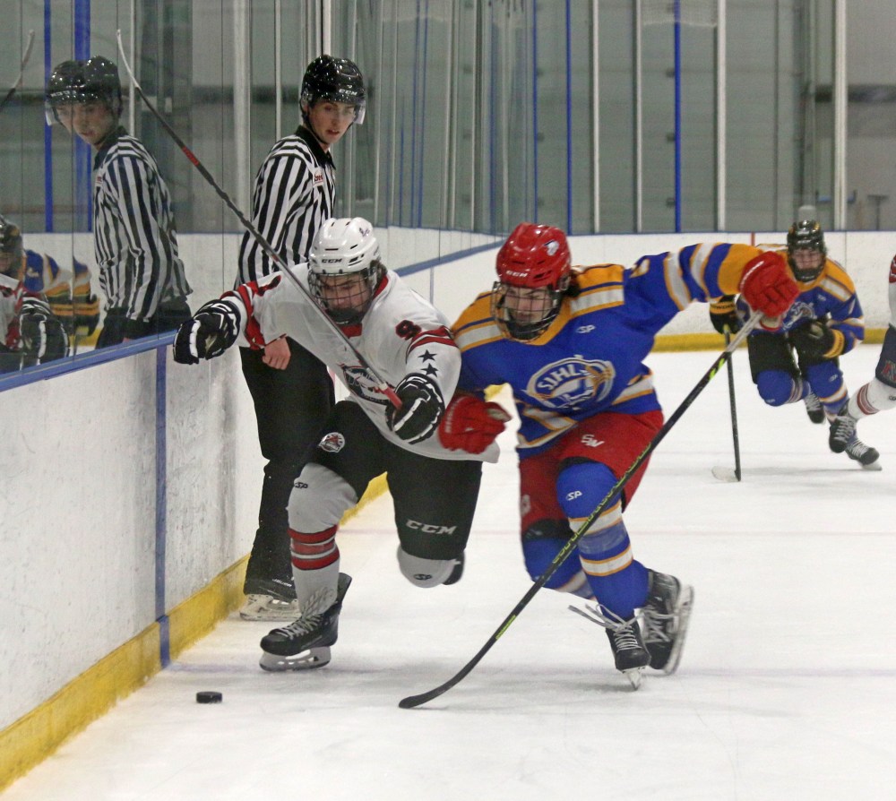 Bryce Bryant, a forward from the Virden Oil Capitals, goes shoulder-to-shoulder with a player from the SJHL during a showcase game Jan. 30. (Cassidy Dankochik The Carillon)