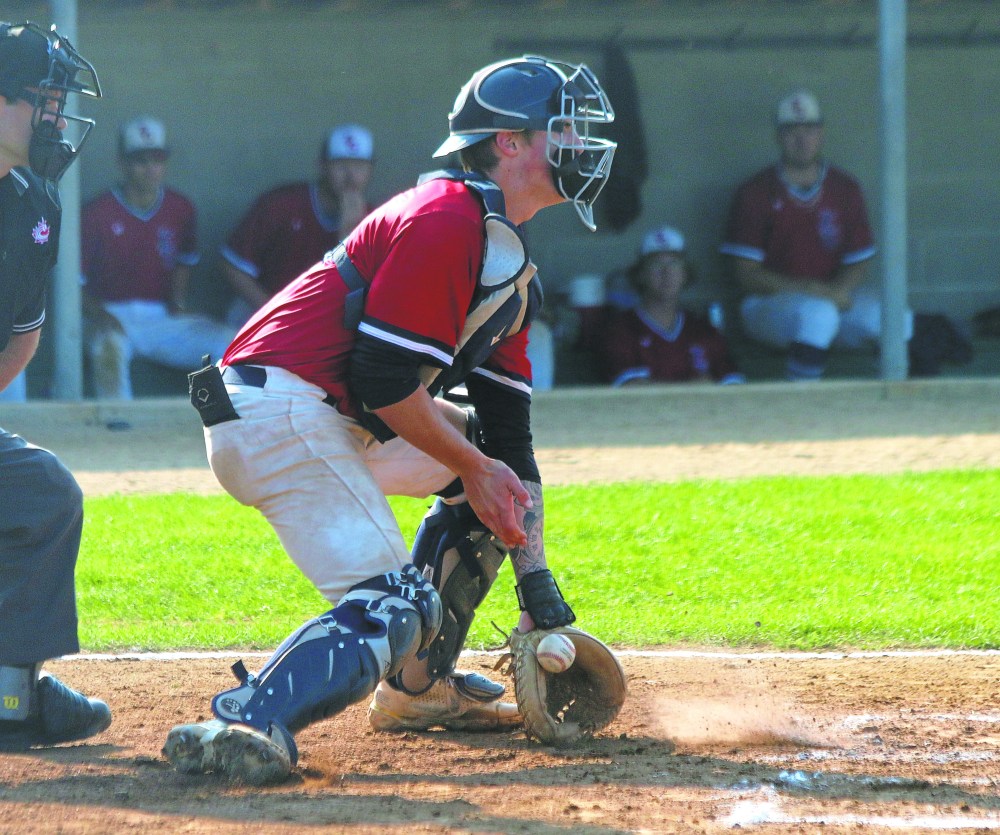 Cody Gunderson nicely blocks a pitch during the semi-finals at the 22U National Championships in Stonewall. Gunderson, probably the province's best catcher, was an easy choice for Elmwood to pick up for their championship run. (Cassidy Dankochik The Carillon)