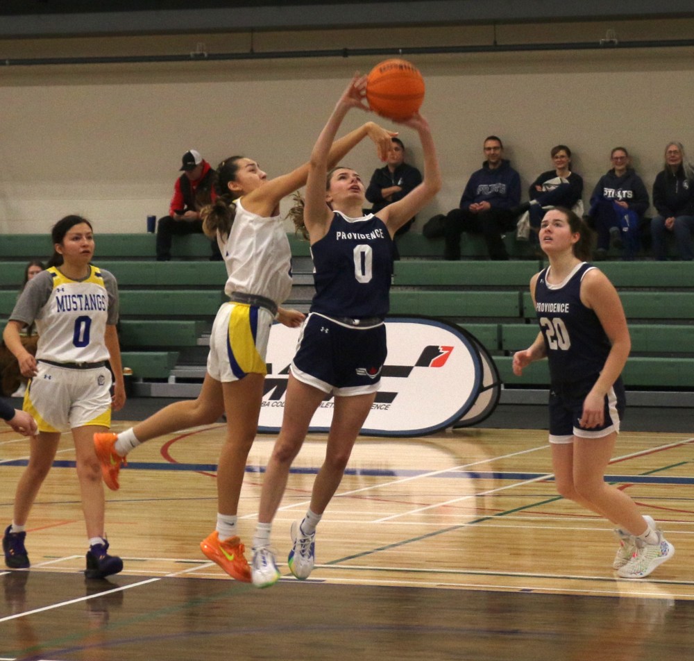 Briana Buchan goes up for a shot while a Sisseton Wahpeton defender tries to stop her. (Cassidy Dankochik The Carillon)