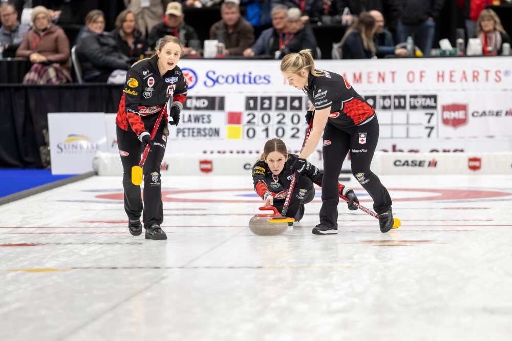 BROOK JONES / WINNIPEG FREE PRESS Skip Kaitlyn Lawes (middle) of Team Lawes from the Fort Rouge Curling Club delivers a rock as second Jocelyn Peterman (left) and lead Kristin MacCuish (right) while competing in the final of 2024 Manitoba Women’s Curling Championships - Scotties Tournament of Hearts presented by Rocky Mountain Equipment at the Access Event Centre in Morden, Man., Sunday, Jan. 28, 2024. Members of Team Lawes also include third Selena Njejovan. Team Lawes earned a 9-8 victory over Team Peterson from the Assiniboine Memorial Curling Club.