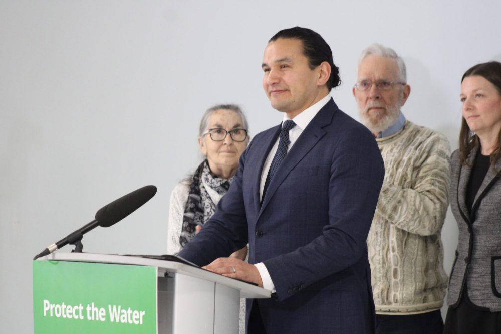 GREG VANDERMEULEN THE CARILLON
Premier Wab Kinew, standing in front of Wendy Mackie, Gord Mackie and Environment and Climate Change Minister Tracy Schmidt, pauses as the crowd applauds the Feb. 16 announcement to deny Sio Silica an environmental licence.