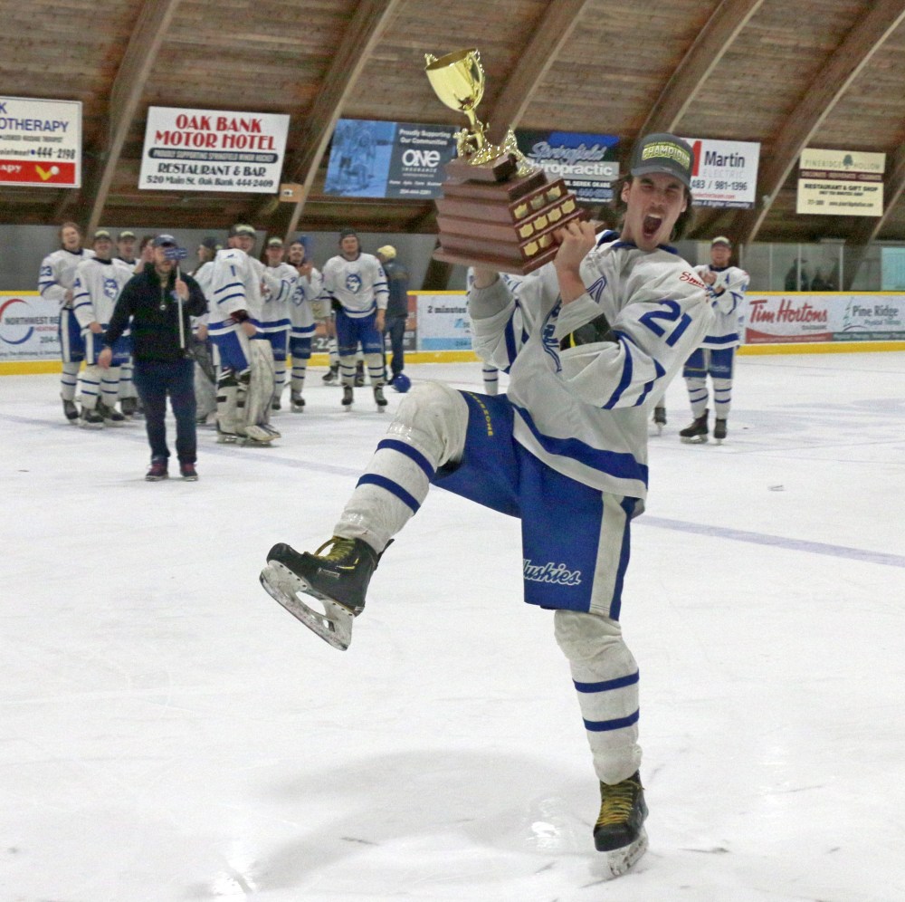 Darius Gagne celebrates with the HTJHL trophy. (Cassidy Dankochik The Carillon)