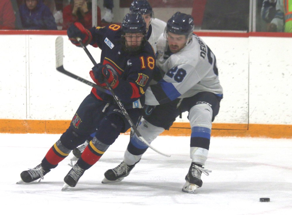 Niverville's Nathan Brown and Steinbach's Hunter Degelman battle for a loose puck during regular season action earlier this season. The two teams will face off for the first time in the playoffs later this week. (Cassidy Dankochik The Carillon)