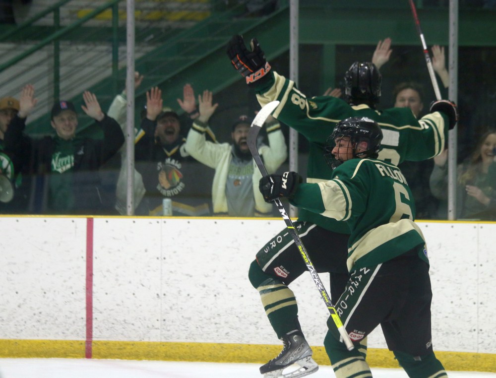 Logan Fillion celebrates with Teagan Fillion after picking up his second goal of game six. Logan's marker would stand as the series winner in a 4-1 victory. (Cassidy Dankochik The Carillon)