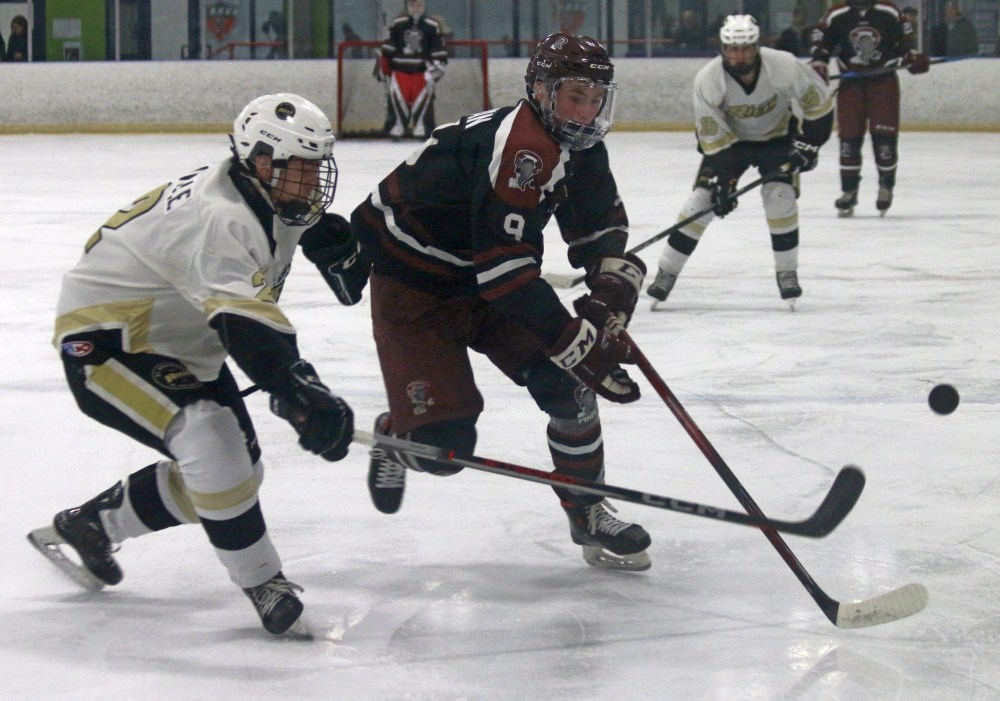 Brett Bergman has the puck knocked off his stick during Pembina Valley's 3-0 victory in game four of their semi-final series against St Boniface. (Cassidy Dankochik The Carillon)