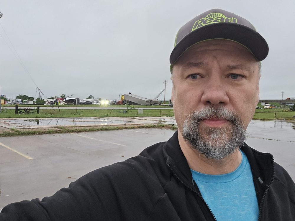 Submitted
James Friesen stands in front of the devastation brought on by a tornado in Oklahoma on Saturday. Luckily, Friesen, a truck driver from Steinbach, wasn’t injured and his truck and trailer took a minor beating from the tornado.