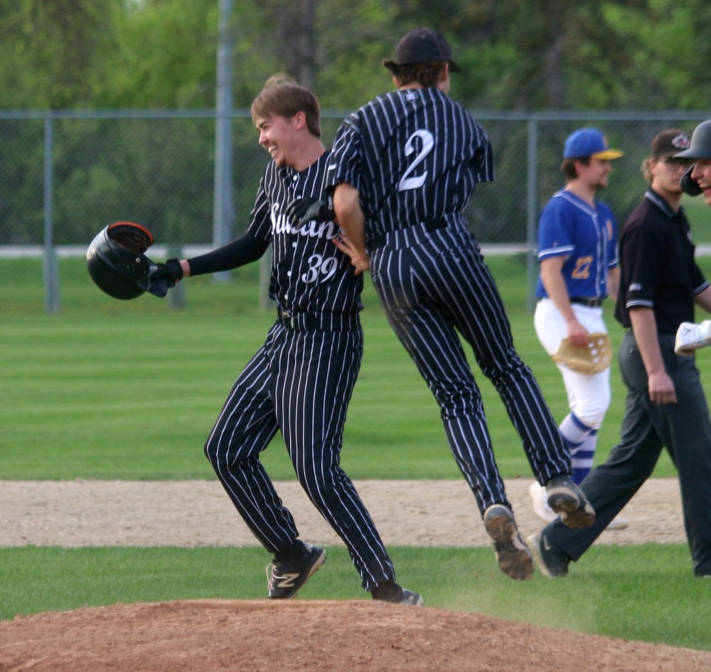 Luc Lagasse was mobbed by teammates after knocking in the winning run in the bottom of the seventh. (Cassidy Dankochik The Carillon)