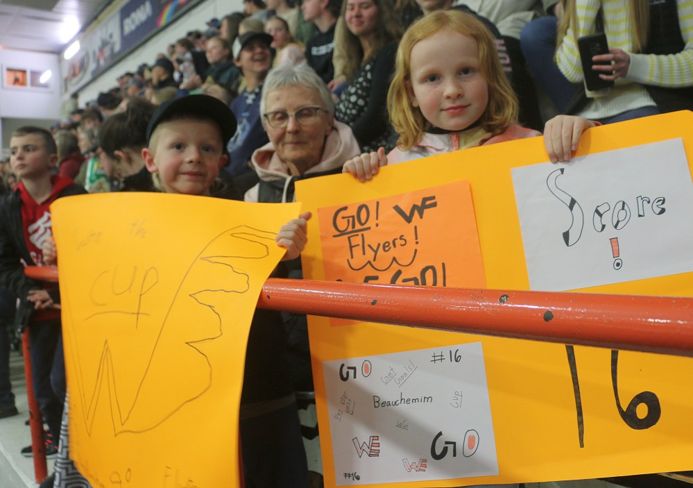 Included in the 1,300 fans inside Winkler's Centennial Arena were cousins of Brody Beauchemin, who brought signs to cheer him on. (Cassidy Dankochik The Carillon)