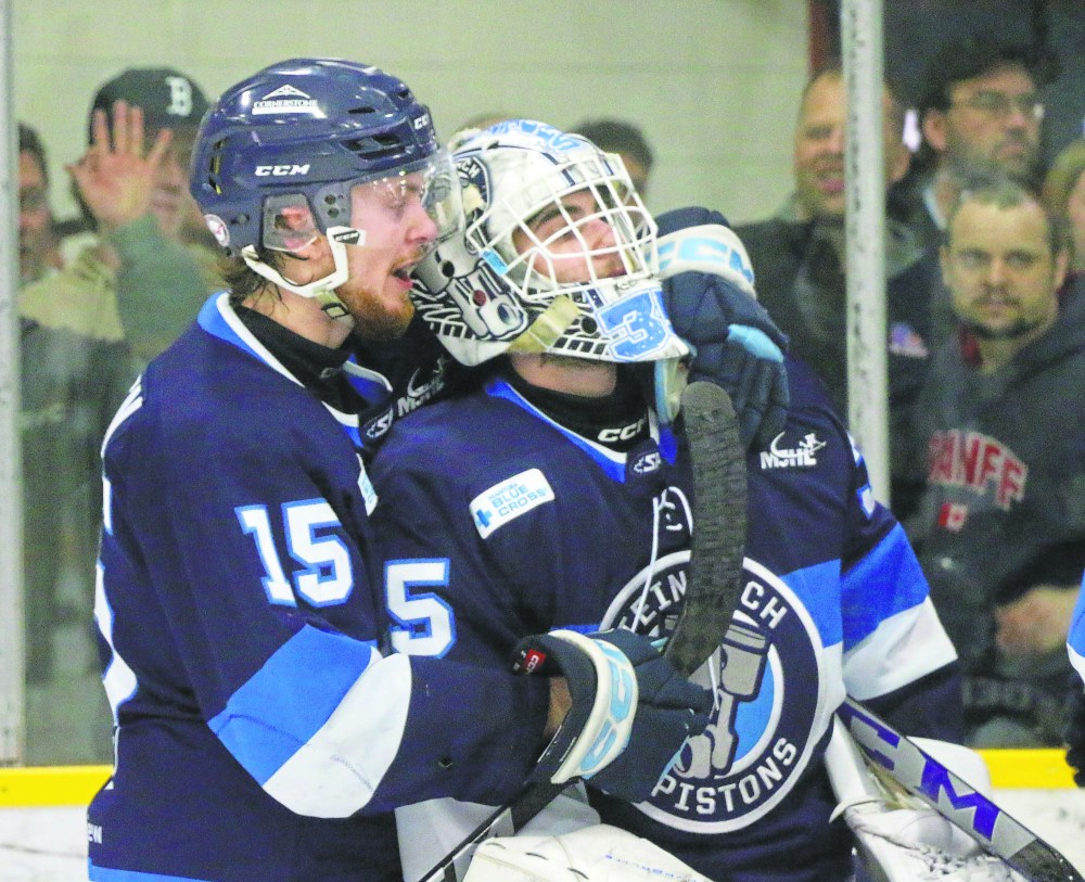 Kirk Mullen consoles goaltender Cole Plowman as Winkler celebrates winning the MJHL final in overtime. (Cassidy Dankochik The Carillon)