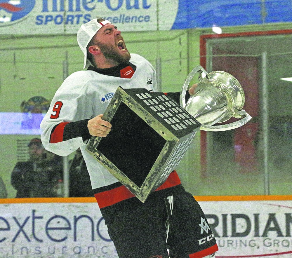 Ile des Chenes' Mike Svenson yells in celebration with the Turnbull cup. Svenson is one of two players from Ile des Chenes to make an impact for Winkler in their championship run. Svenson and Brody Beauchemin even played their minor hockey together as Atom players. (Cassidy Dankochik The Carillon)
