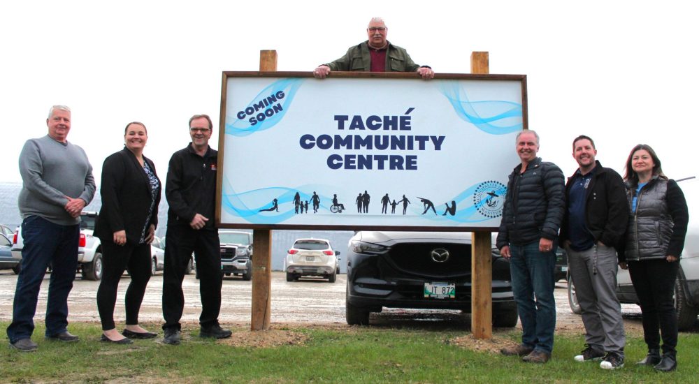 CHRIS GAREAU THE CARILLON
Tache Mayor Armand Poirier (centre) and councilors (left to right) George McGregor, Natashia Lapeire, Steven Stein, Marcel Manaigre, Steven Bowker and Dawn Braden at the newly erected sign touting the soon-to-come Tache Community Centre in Lorette May 14. The centre is to be the home of a new arena, library and more and is now estimated to cost $29.5 million.
