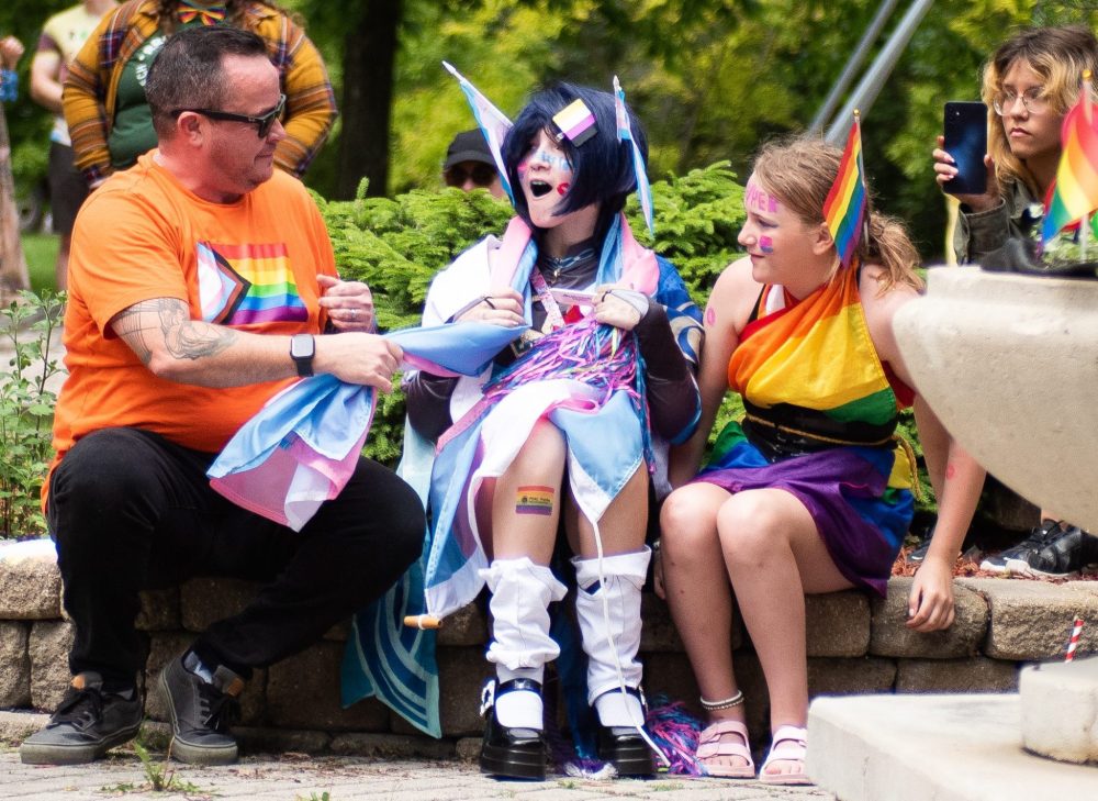 SVJETLANA MLINAREVIC THE CARILLON
Hayden Lessard is surprised to have the transgender flag drapped around her shoulders by NDP MLA Logan Oxenham as her friend Payton Lagasse looks on during Steinbach Pride on June 23, 2024, at K.R. Barkman Park. Oxenham is Canada's first transgender MLA to win a seat in the legislature. In early June, he introduced a bill commemorating transgender and two-spirit people, which passed.