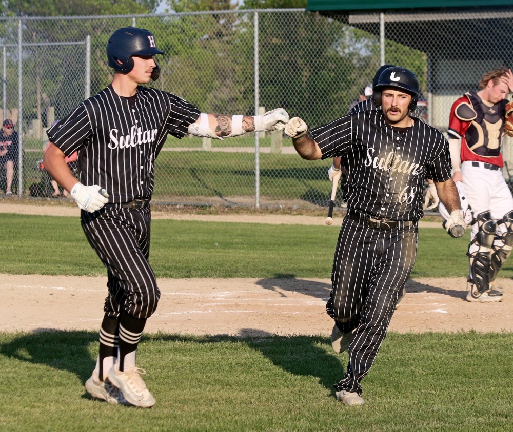Cody Gunderson and Brady Papineau fist-bump after a Gunderson sac-fly scored Papineau during Carillon's game against Elmwood May 31. Although the Sultans would drop that game 5-4 for their their first loss of the season, the team rebounded by sweeping a double-header against Winnipeg South May 31. The pair of college sluggers have been raking since Gunderson returned to Manitoba, especially in game two of the double-header, where they combined to go 4/4 with two walks and 3 RBIs. (Cassidy Dankochik The Carillon)