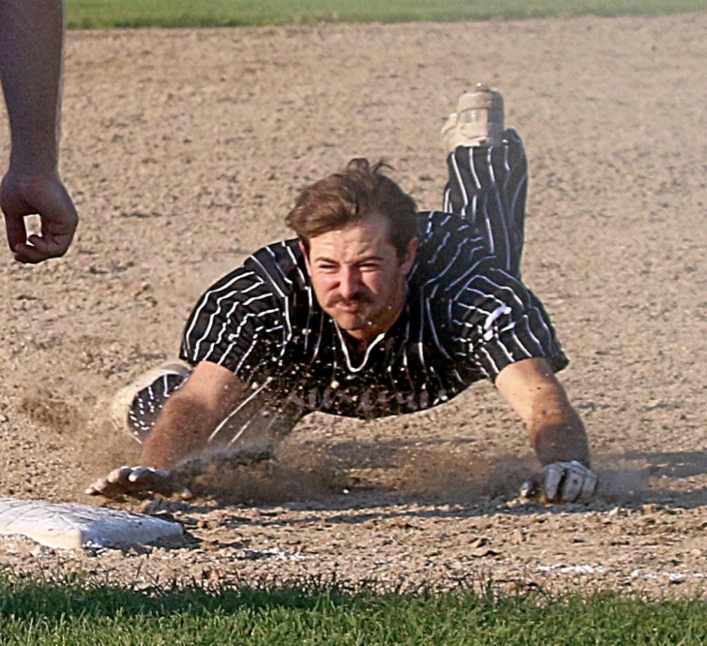 Brady Papineau slides safely into third base after running past a stop signal from his third base coach to record a triple during Carillon's 5-4 loss to Elmwood May 31. (Cassidy Dankochik The Carillon)