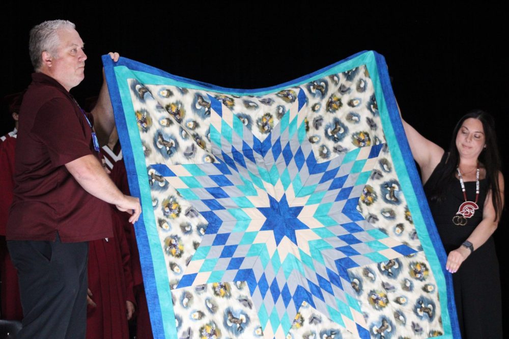 GREG VANDERMEULEN THE CARILLON
Principal Jason Mateychuk and Vice Principal Jennifer Collette hold up one of the Star blankets created for each graduate.