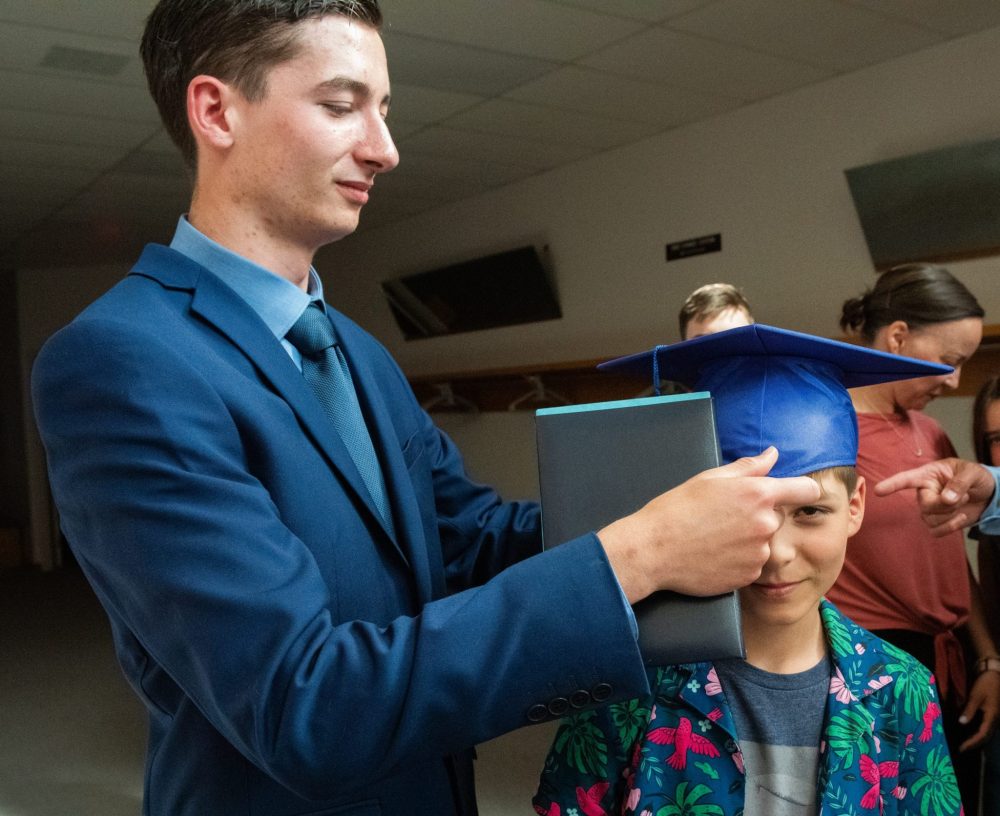 SVJETLANA MLINAREVIC THE CARILLON
Landmark Collegiate graduate Stefan Favreau puts his cap on his brother Rhys after the graduation ceremony on June 26, 2024, at Prairie Rose Evangelical Mennonite Church.